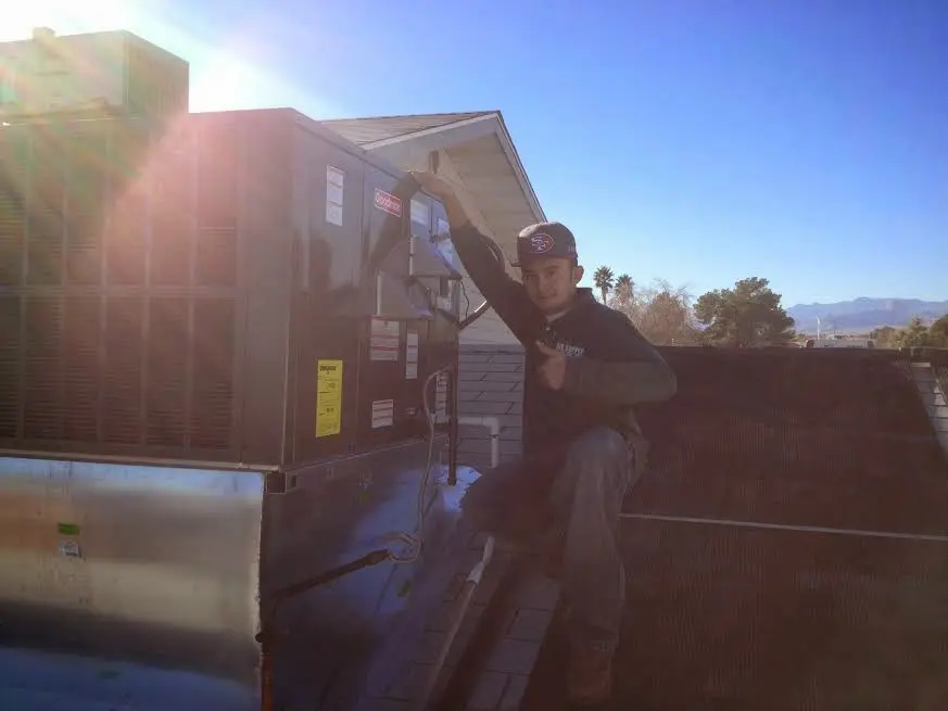 HVAC technician performing HVAC Inspection on a rooftop unit in North Hanover
